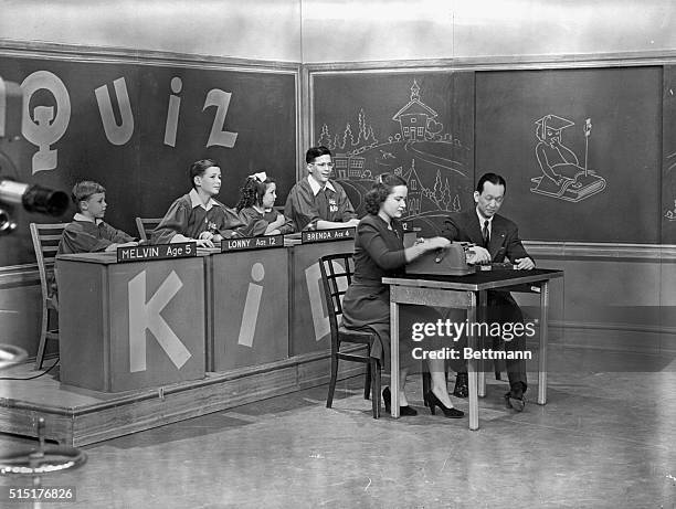 Television show: "Quiz Kids." Joel Kupperman beats adding machine and Chinese abacus in adding race on television. Undated photograph.