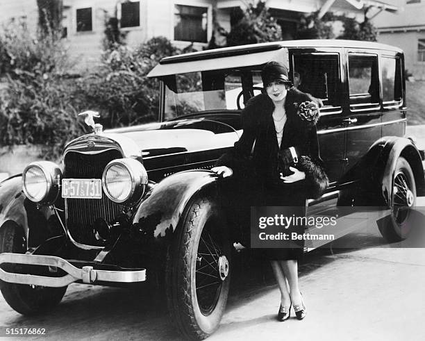 Lincoln of 1926 with Vilma Banky standing alongside. Photograph.