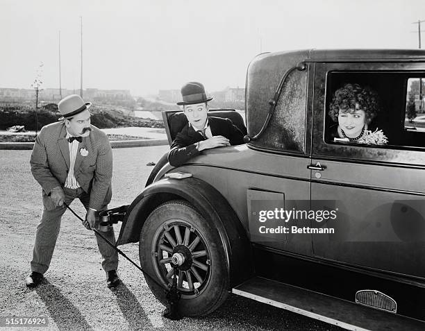 Vernon Dent, Harry Langdon and Ruth Hiatt in a scene from "Saturday Afternoon." Girl in car winks at young man in rumble seat while second man is...