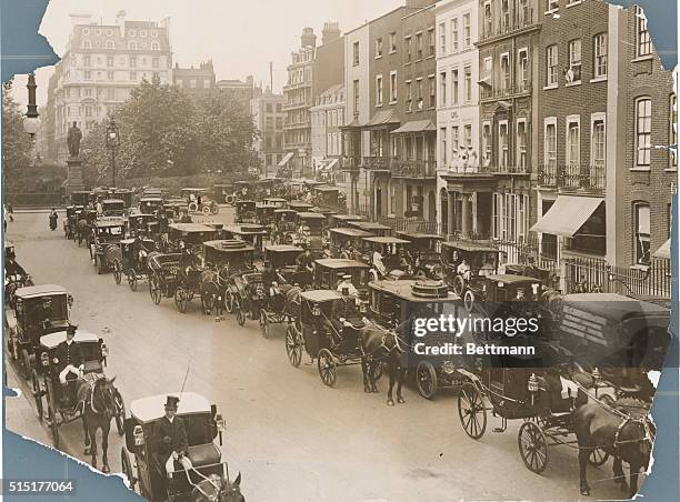 Hanover Square, London, England-: Typical London Scene: Fashionable carriages with horses and automobiles in front of a strip of town houses. Undated...