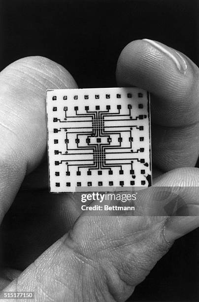 Closeup of a ceramic substrate patterned with high-temperature superconducting wires made with a new IBM plasma spray technique. Such wires might be...