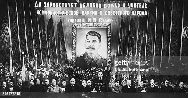 Moscow, USSR: While a huge portrait of the guest of honor beams down from the rear like "Big Brother" Communist top brass pay honor to Marshall Josef...