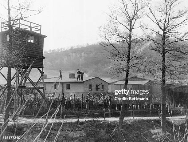 Bad Sulza, Germany: British, French, Russian, and a few American prisoners of war wave and cheer as American tankers pass their enclosure in Bad...