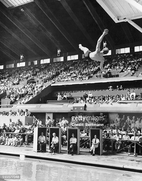 London, England: Bruce Harlan of Ohio State makes his final dive to win the Men's Springboard Diving event at the Empire Pool on July 31. Americans...