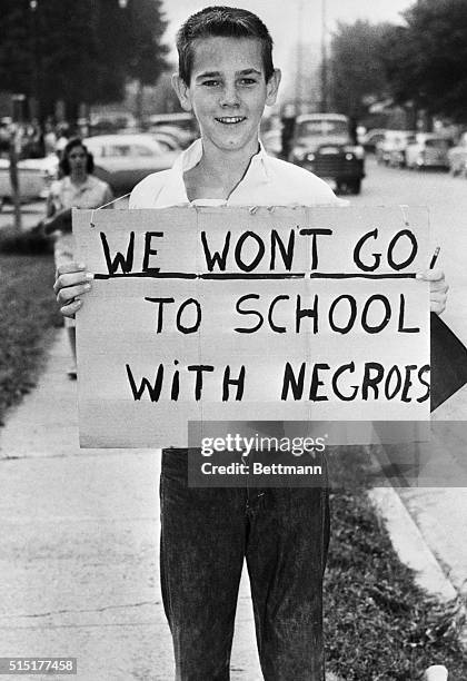 Clinton, TN: John Carter a Clinton High School junior, carries sign outside the school here August 27th. Protesting racial integration as the school...