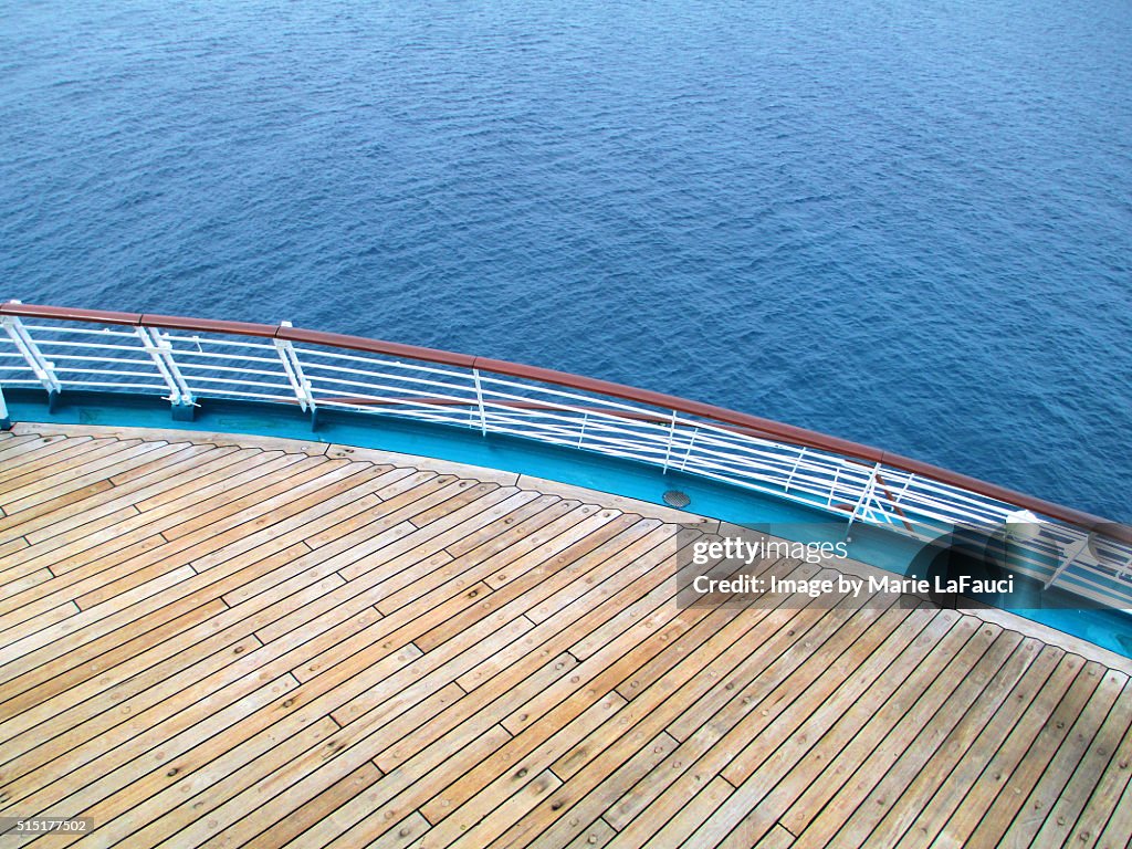 Aerial view of cruise ship stern with deck & railing