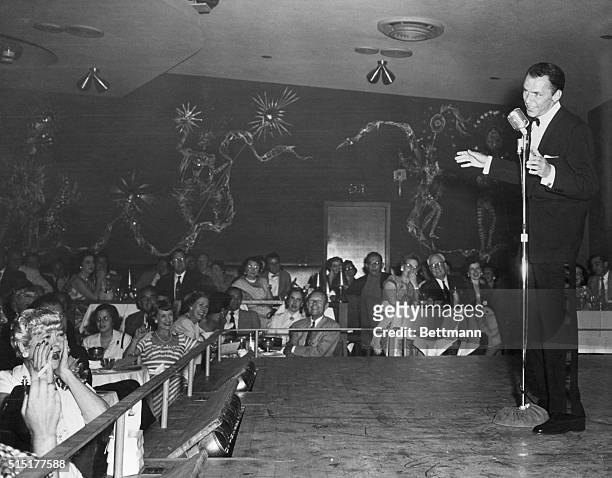 Las Vegas, NV: Frank Sinatra singing at the opening of the new Ziegfeld Follies at the Sands in Las Vegas. Woman at lower left overcome by emotion is...