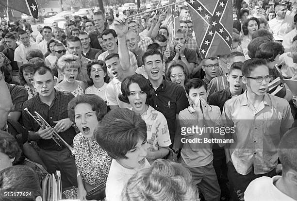 Birmingham, AL: Demonstrating students wave a Confederate flag as they chant and jeer outside West End High School. Three Birmingham schools were...