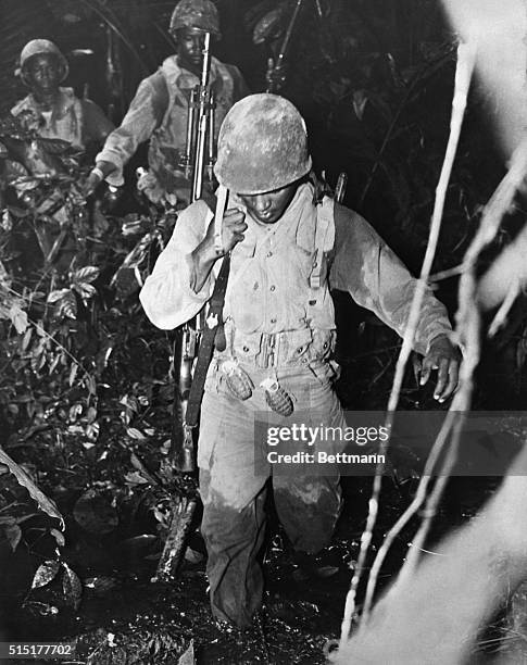 Black soldiers, World War II; 93rd Infantry Division detachment landing in the jungles of Bougainville, South Pacific. Undated photograph.