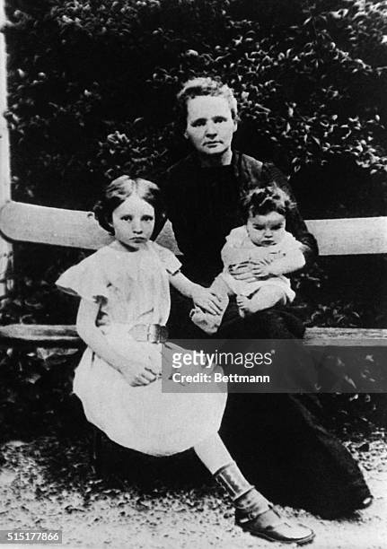Nobel Prize-winning chemist Marie Curie poses with her daughters Irene and Eve .