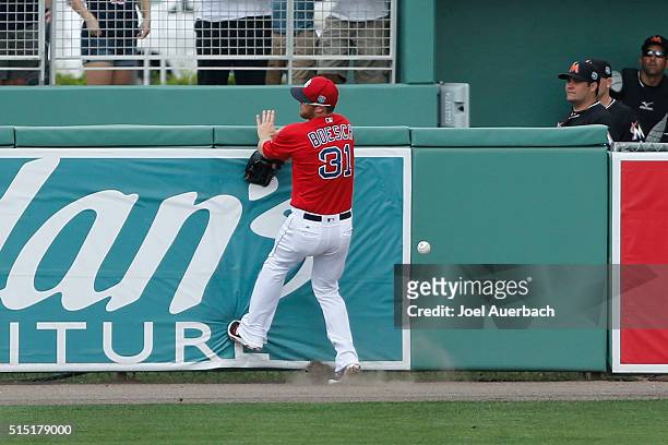 Brennan Boesch of the Boston Red Sox is unable to catch the ball hit by Tomas Telis of the Miami Marlins for a double in the eighth inning during a...