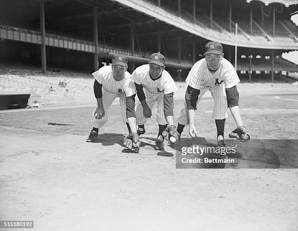 New York, NY: Pre-game at Yankee Stadium, L to R: Andy Carey, Phil Rizzuto and Gil McDougald line up, Yankee infield. Photograph, April 11, 1952.