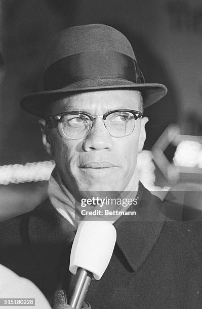 Malcolm X is interviewed by television reporters during a Nation of Islam demonstration in Times Square, protesting the arrest of African Americans...