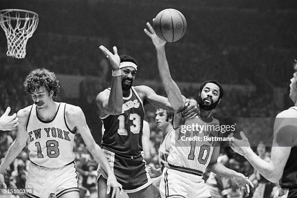 New York, NY - Wilt Chamberlain , of the Los Angeles Lakers, grabs Walt Frazier , of the New York Knicks, around the shoulder and appears to be ready...