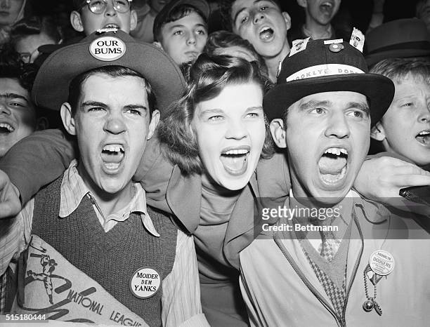 New York, NY: These Brooklyn rooters get an early start cheering the Dodgers on to victory, so they hope. Noisemakers in the bleacher stands before...