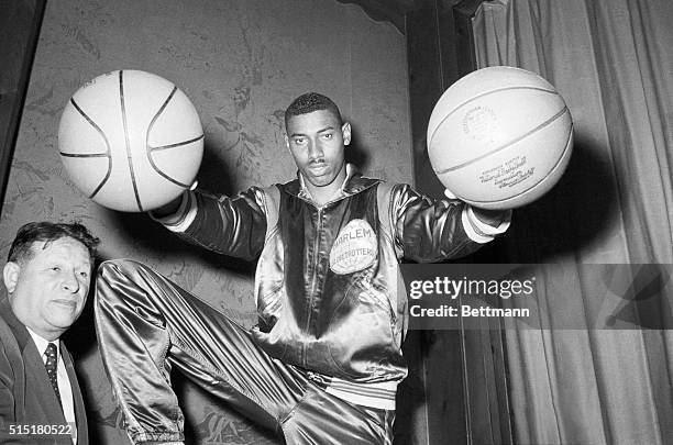 New York, NY- Wilt "The Stilt" Chamberlain, twice All-American at the University of Kansas, bedazzles Harlem Globetrotters' boss Abe Saperstein with...