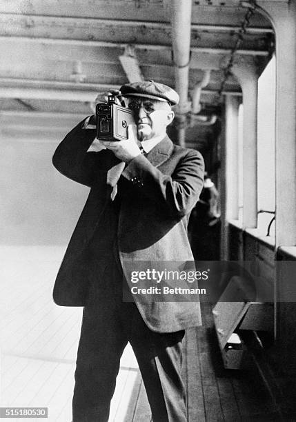 George Eastman taking pictures with a Kodak camera.