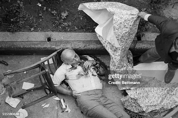 New York, NY: The body of reputed Mafia leader Carmine Galante is covered by New York police detectives here July 12 at a Brooklyn restaurant after...