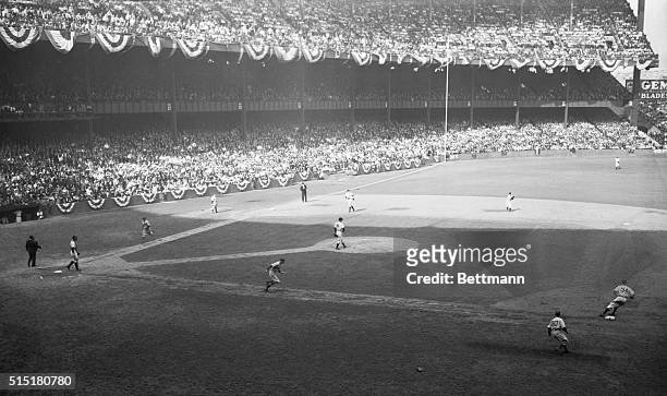 New York, NY: Original caption reads as follows- Shortstop Phil Rizzuto of the NY Yankees gets pitcher Curt Davis of the Dodgers to retire the side...