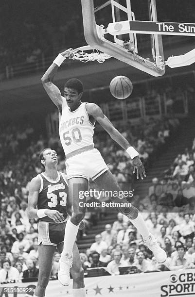 Houston, TX: Houston Rockets' Ralph Sampson slams the ball through over his shoulder for two points during a playoff game in Houston.