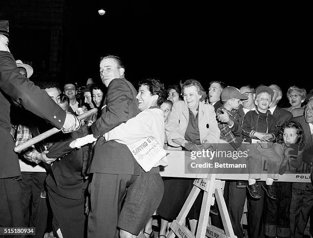 Woman Dodger fan broke the police lines to hug Peewee Reese, Dodger Captain, as he arrived this evening at Hotel Bossert for the club's victory...