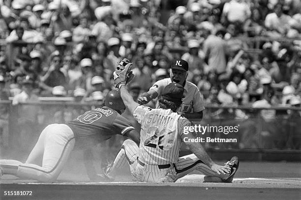 Philadelphia, PA- Phillies' third baseman Mike Schmidt holds up the ball as Ump Doug Harvey calls Cubs' Leon Durham out at third in the fourth...