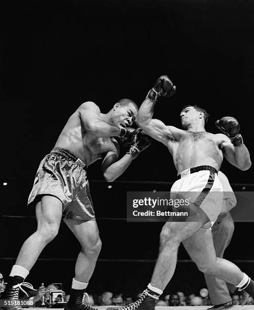 New York, NY- Joe Louis appears shaken by a right uppercut from Rocky Marciano during their scheduled 10-round bout at Madison Square Garden....