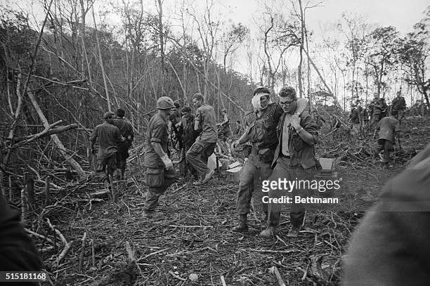 Shau Valley, South Vietnam- Wounded American soldiers are assisted by buddies during Operation Delaware in this valley in South Vietnam's Quang Tri...