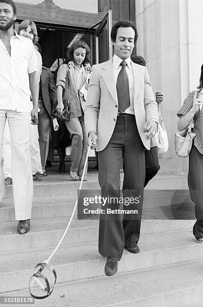 Oakland, CA- Black Panther co-founder Huey Newton leaves Alameda County Courthouse with a battery-operated leash connected to a hovering dog harness...