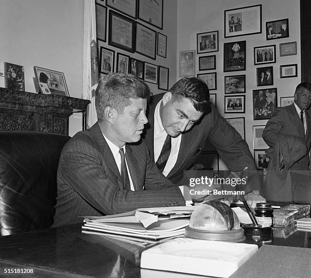 Washington, D.C.- Back to work after a visit to wife and infant son at he hospital, president-elect Kennedy confers with Press Secretary Pierre...