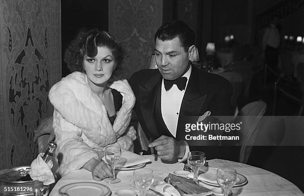 Former heavyweight champ Jack Dempsey dines at the Ambassador Hotel's Cocoanut Grove nightclub with his wife, Broadway singer Hannah Williams.