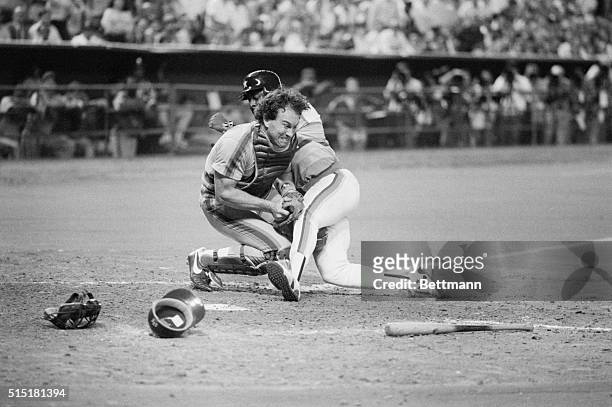 Houston, TX- Mets catcher Gary Carter grimaces but holds onto the ball as he tags out Astros' Billy Hatcher, who was trying to score from 3rd on an...