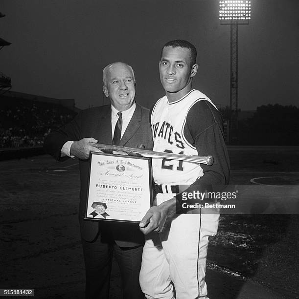 National League President Warren Giles presents the 1965 National League Batting Champion Roberto Clemente, of the Pittsburgh Pirates, with a silver...