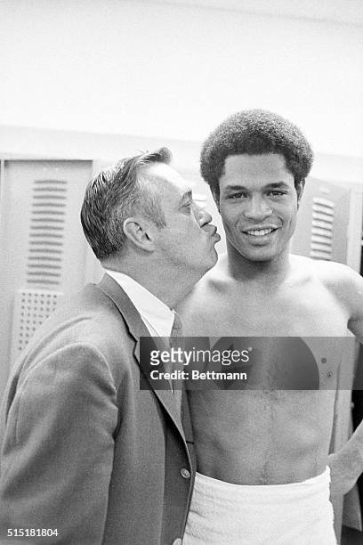 Dayton, Ohio- Notre Dame's head basketball coach Johnny Dee gives his star player Austin Carr a big kiss after Carr set a new all time NCAA single...