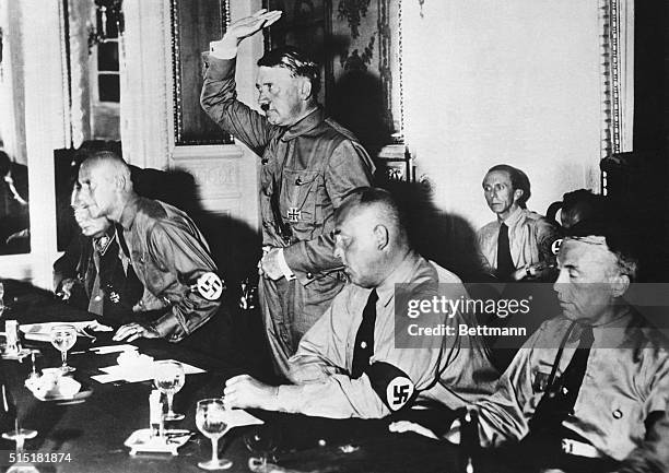 Adolf Hitler, leader of the Nazi Party, presided over a meeting of 230 Nazi members taking the oath of allegiance after the meeting. Left to right:...