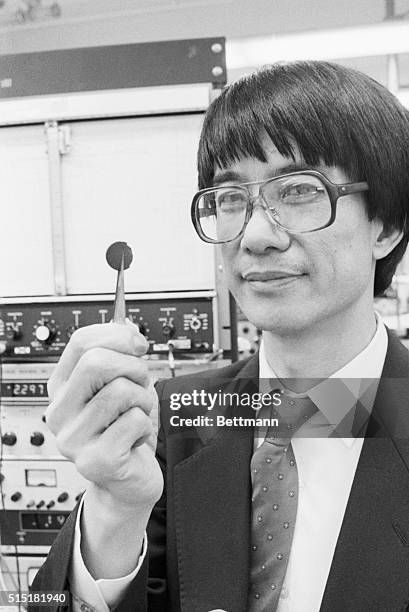 Houston, TX- Physicist Dr. Paul Chu of the University of Houston holds an experimental superconductor which, when cooled in liquid nitrogen to minus...