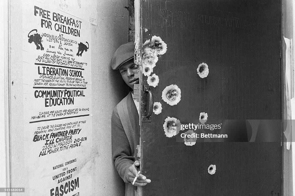 Black Panther Standing Behind Bullet-Riddled Door