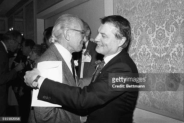 Researcher Luc Montagnier hugs Jonas Salk, developer of the polio vaccine, after they were both presented medical research awards by the Albert and...