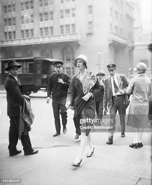 New York, NY- Society Matron Mrs. Robert McAdoo walks down Park Ave. Photograph shows her crossing the street with onlookers.