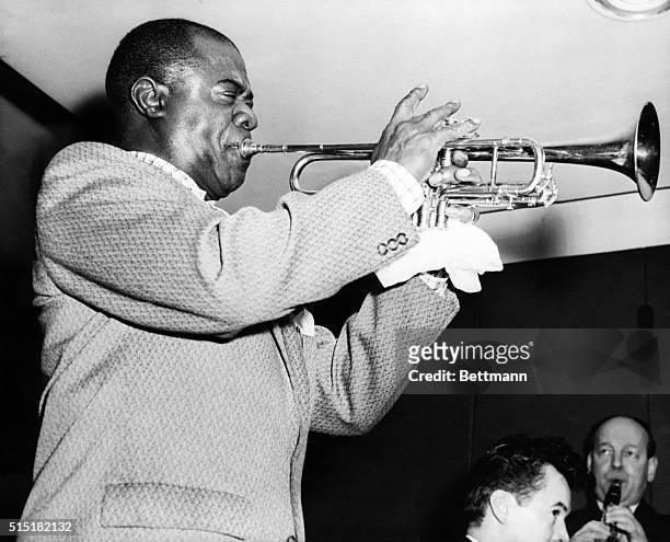 Louis Armstrong practices his trumpet at a rehearsal at Royal Festival Hall in London.