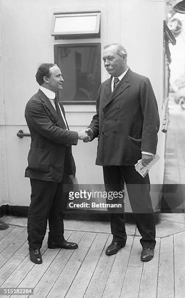 Harry Houdini and Sir Arthur Conan Doyle shake hands as Doyle prepares to depart for the UK on the SS Adriatic after his visit to the United States.