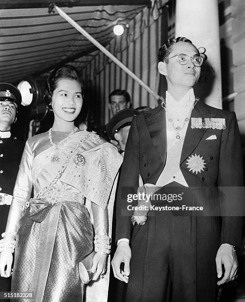 King Bhumibol Adulyadej of Thailand, aka Rama IX, and wife Queen Sirikit Kitiyakara arrive at the Thai embassy at Ashburn Place in London, United...