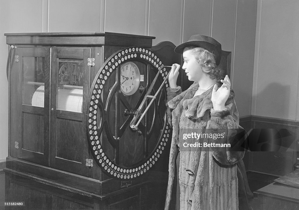 Woman Punching in on Rotary Time Clock