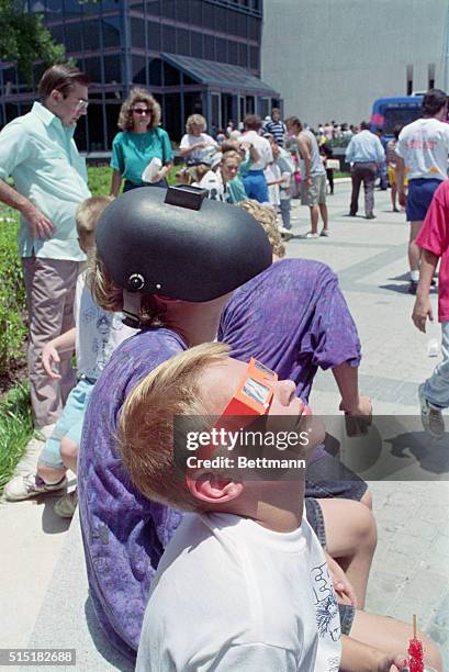 Houston, TX- Staring at the solar eclipse brings other stares for two Houston youngsters at the Houston Museum of Natural Science. Kevin Brown...