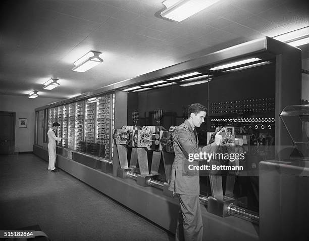 Computer operators work on an early computer created by Howard Aiken for IBM. IBM presented the computer to Harvard University to be used by the US...