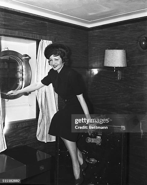 New York, NY- Pictured just before she sailed today on the S.S. Conte Di Savoia is Claudette Colbert, film star, who is enroute to France for a...