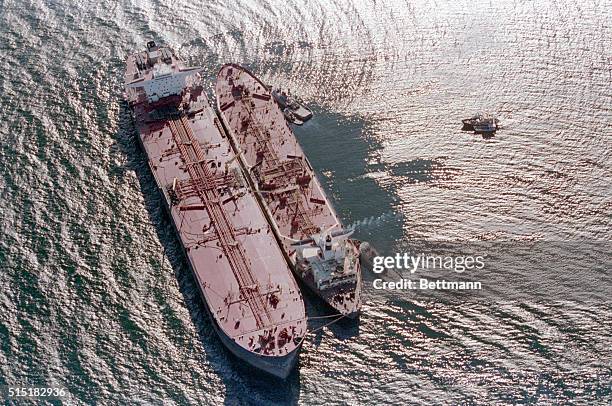 Valdez, Alaska- Oil from the stricken tanker, Exxon Valdez, is pumped aboard the Exxon Baton Rouge, as clean-up efforts continue in the Prince...