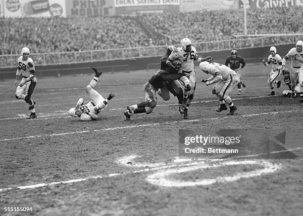 New York, NY - ORIGINAL CAPTION READS: Marion Motley, Cleveland Browns Fullback is tackled after a 15-yard kick return in the 2nd quarter of a game...