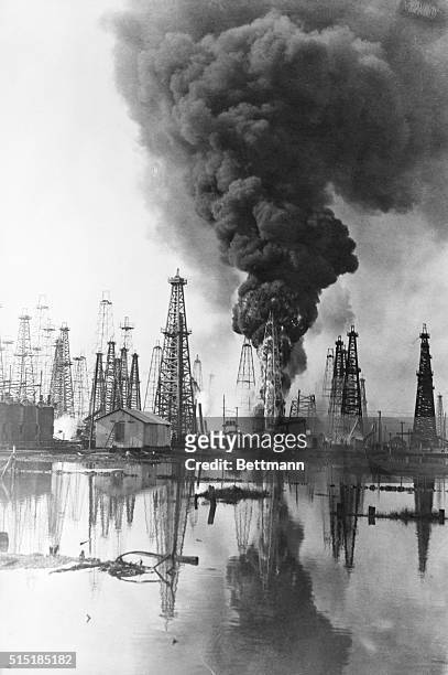Spindle Top, TX - Photo shows oil well here with flames shooting 150 feet in the air. The fire burned 16 hours doing $100,000 damages. The heat...