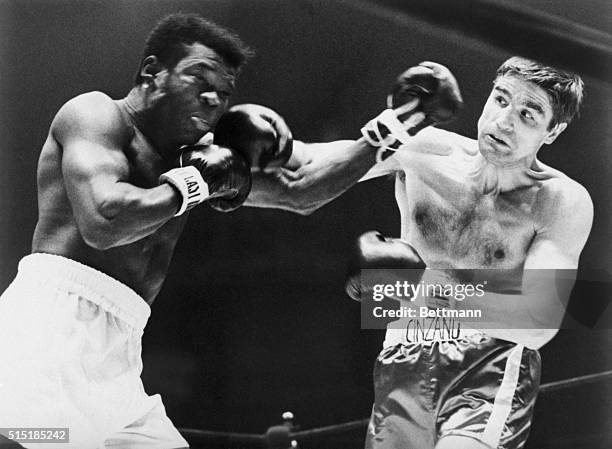 Nino Benvenuti is tensed up as he delivers a right to the jaw of Emile Griffith during their 1968 title bout. Nino challenged and won the crown.